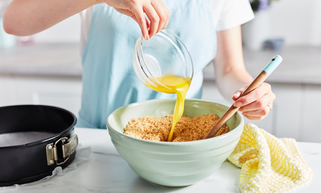 Picture - Pouring melted butter into biscuits